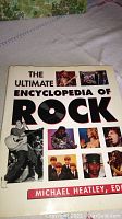 Front cover of The Ultimate Encyclopedia of Rock showing photos of musicians and the editor's name.