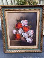 Full view of framed oil painting showing floral bouquet with red and white flowers and carved ornate frame with fabric liner.