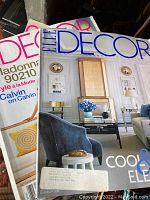 Close-up of front covers of Elle Decor magazines showing design and fashion themes.