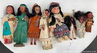 Overview of all 8 vintage First Nations dolls showing various traditional outfits and styles