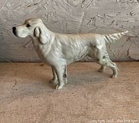 Full side view of the English Setter dog porcelain figurine showing its posture and details.