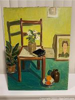 Full view of the signed Anton Paczolay oil painting still life showing a wooden chair with flowers, book, small jug, bowl of fruit, and framed portrait against green background.