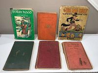 Five vintage children's books arranged upright and flat showing covers and general condition