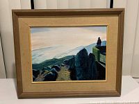 Full view of framed acrylic painting showing a person overlooking a rocky landscape at sunset, capturing the entire artwork and frame.