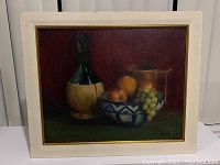 Frontal view of the framed signed oil painting depicting a still life with fruits and vessels, showing overall condition.