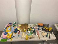 Overview of assorted cleaning tools and supplies on table