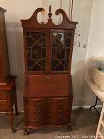 Full front view of the wood secretary and curio cabinet showing glass doors and drop front desk section