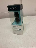 Fitbit Charge wireless activity wristband in original packaging, black color, size small, shown sealed in plastic display box.