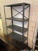 Front and side view of metal shelving unit showing all five shelves and cross-bracing.