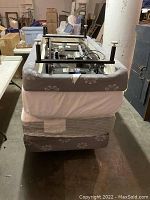 Side and underside view of the electric adjustable twin XL bed base with grey floral fabric