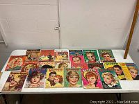 Overview of 18 vintage movie star magazines laid out on a white table, including Silver Screen, Screen Romances, Radioland, Radio Stars, and others.
