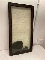 Front view of the wood display cabinet showing the glass front and wooden frame.