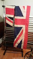 Two British Union Jack flags shown; one hanging and one draped with visible Union Jack design and colors.