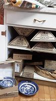 Stacked boxed 3-piece dinner sets labeled Churchill Classic Blue Willow from England