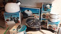 Photo showing the entire Barcelona cookware set including kettle, pan, pot, and 8 covered soup casseroles in their original boxes arranged together.
