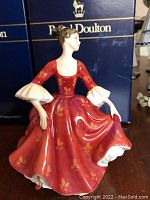 Front view of the Royal Doulton Stephanie porcelain figurine, showing detailed butterfly pattern on flowing red dress and delicate pose.