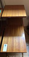 Top view of two matching wood side tables showing upper and lower shelves
