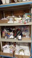 Shelving unit with organized craft supplies including boxes, letters, and glue tool.