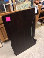 Front and side views of a dark brown laminate folding desk with curved cutout and metal folding mechanism.