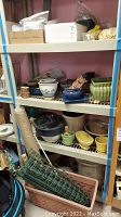 Photo of shelves containing multiple pottery planters, plastic rolls, and planting pots in various colors and sizes