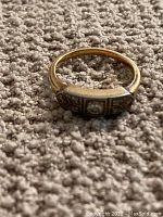Ring resting on carpet showing top profile and band shape