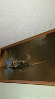 Photo showing the airplane wall art from a distance, capturing the airplane with spinning propeller against the sky.