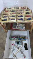 Full view of all items including 17 Chevron toy cars in boxes and additional small toy cars and model plane.