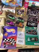 Photo showing various diecast car models including Chevron cars, Matchbox cars, Hot Wheels, and Revell airplane box