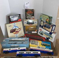Full lot showing boxed Corgi model buses and train cars with American Freedom trains. Includes several scale models and original packaging.