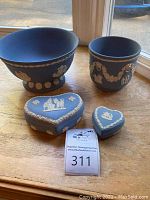 Photo showing the footed bowl, vase, and two heart-shaped ring boxes on a wooden surface.