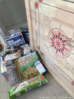 Wide photo showing most of the lot items and carrom board edge.