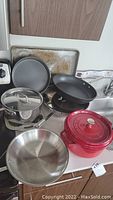 Overview of entire lot on countertop showing all pans, pot, Dutch oven, bundt pan and cookie sheet