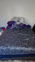 Full view of queen size bed made with bedding, pillows, and visible bed frame