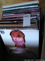 Box of vinyl LP records with David Bowie 'Aladdin Sane' cover visible