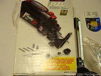 View of Bosch Roto Zip Spiral Saw box with image of the spiral saw and 7 bits layout.
