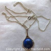 Full view of sterling silver pendant with lapis lazuli stone on chain, showing chain length and pendant size