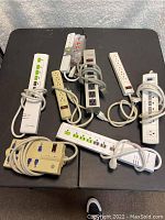 All seven power strips and surge protectors displayed on a flat surface with cords wrapped.