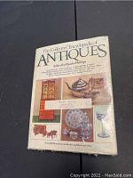 Front cover of 'The Collectors' Encyclopedia of Antiques' showing various antique illustrations and the editor Phoebe Phillips noted.