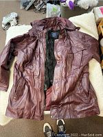 Front view of the burgundy real leather jacket showing size 2XL and overall condition.
