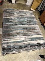 Top view of the rectangular area rug laid out flat showing the full pattern and color details.