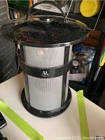 Front view of black Acoustic Research Bluetooth portable speaker showing metal handle on top and mesh speaker body