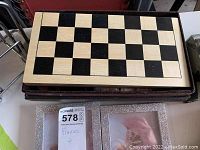 Top view of wooden chess and checkers board closed showing light and dark square pattern