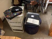 Photo showing the metal storage cart, fabric stool, salon jackets in package, black toque hat, and insulated lunch bag.