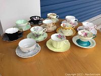 Overview of the 11 various floral patterned vintage china tea cups and saucers.