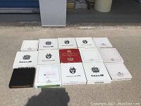 Various empty and closed original boxes and sleeves for collector plates with different steam train and Red Rose Tea marked covers