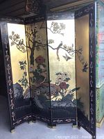 Front view of the four-panel dressing screen showing floral and bird designs on gold background with black borders.