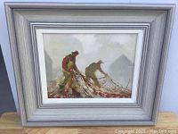 Front view of framed painting depicting two fishermen with nets