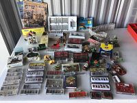 Wide view of entire lot showing multiple blister packs of HO scale figures, hobby magazine, vehicles and loose accessories