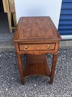 Front view of end table showing drawer and shelf