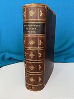 Spine of the leather bound book 'Wordsworth's Poetical Works' showing gold embossed title and decorative designs.